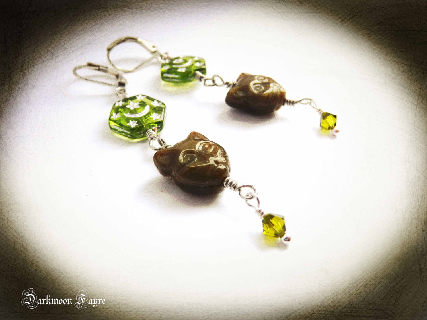 Celestial Feline Smoky Topaz Glass Cat Earrings. Hexagonal Glass Star & Moon Beads. Olive Swarovski Bicone Crystal Dangles. Silver Plated. - Darkmoon Fayre